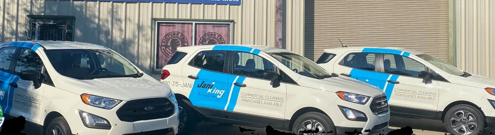 Jani-King fleet outside the Picture This Wraps & Graphics shop